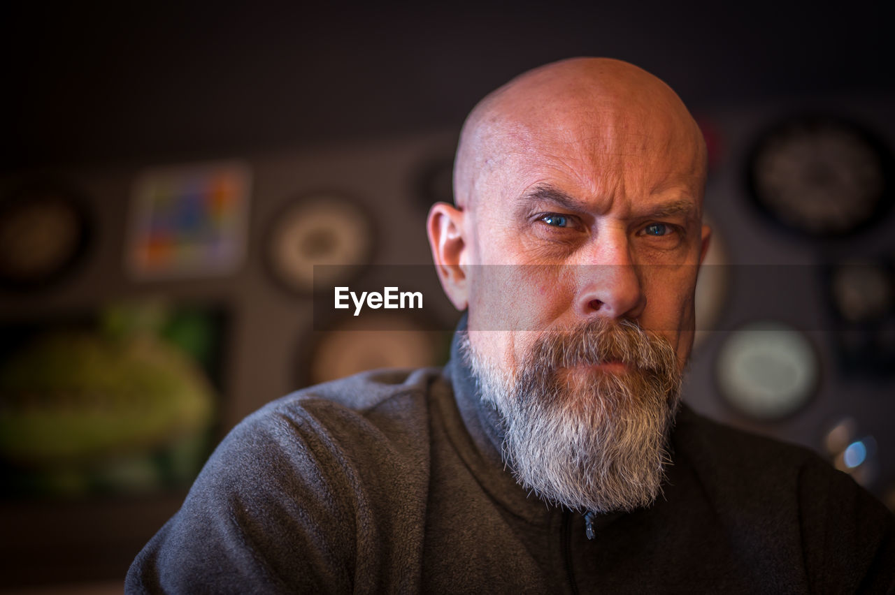 Older man with gray beard looking serious