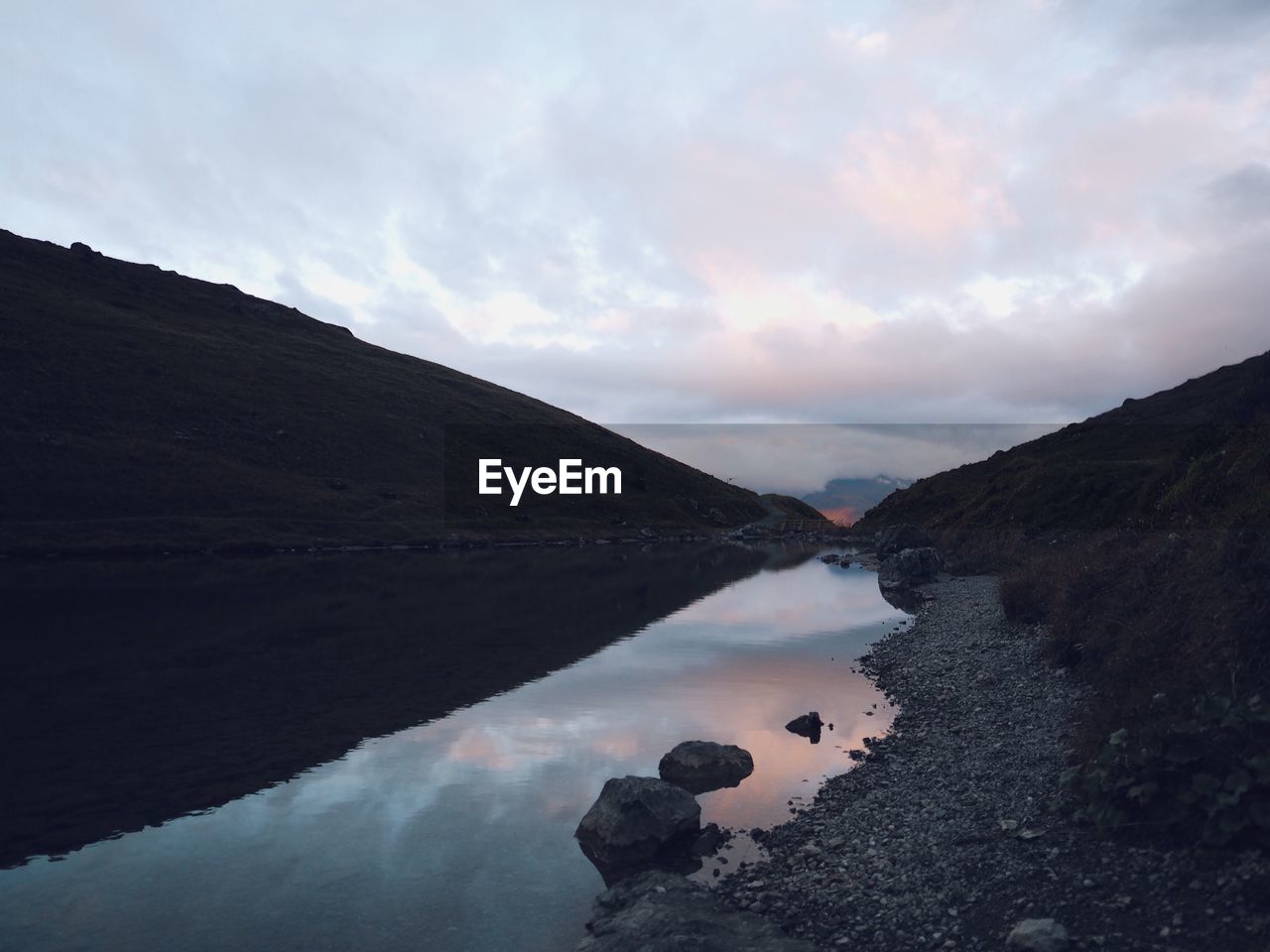 Scenic view of lake amidst mountains against sky