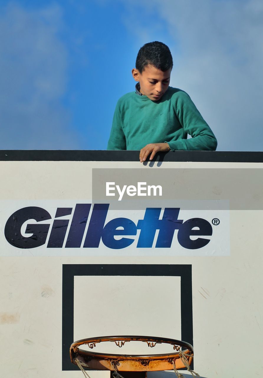 FULL LENGTH OF BOY STANDING ON WALL