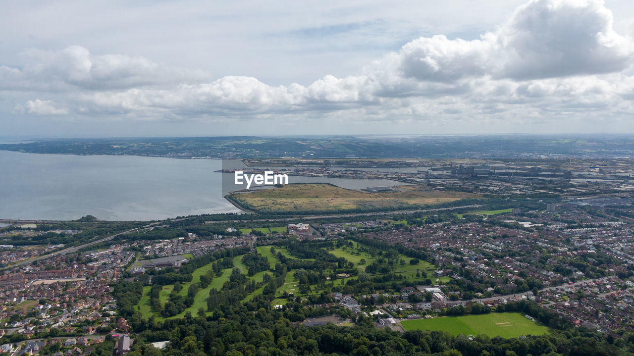 AERIAL VIEW OF CITY AND SEA AGAINST SKY