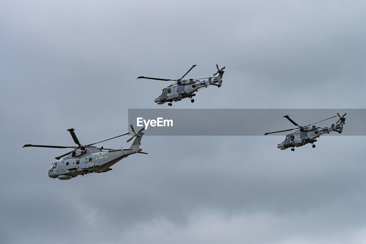 LOW ANGLE VIEW OF AIRSHOW AGAINST SKY