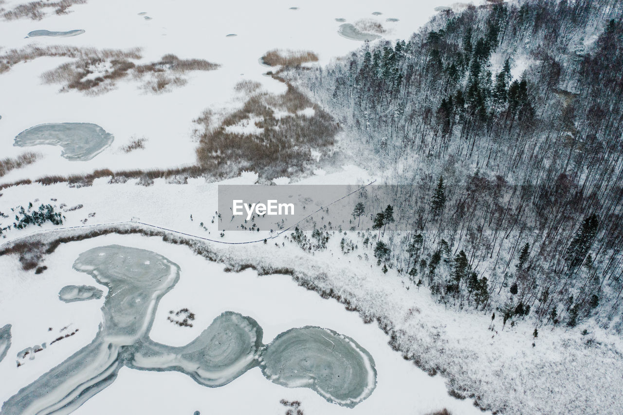 SCENIC VIEW OF SNOW COVERED TREES BY SNOWCAPPED MOUNTAINS