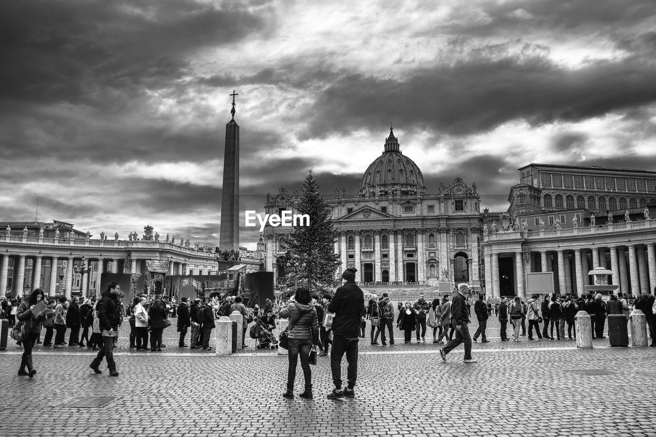 Group of people walking in front of buildings