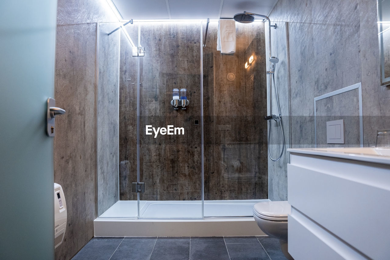 Interior of elegant illuminated modern bathroom in luxurious hotel