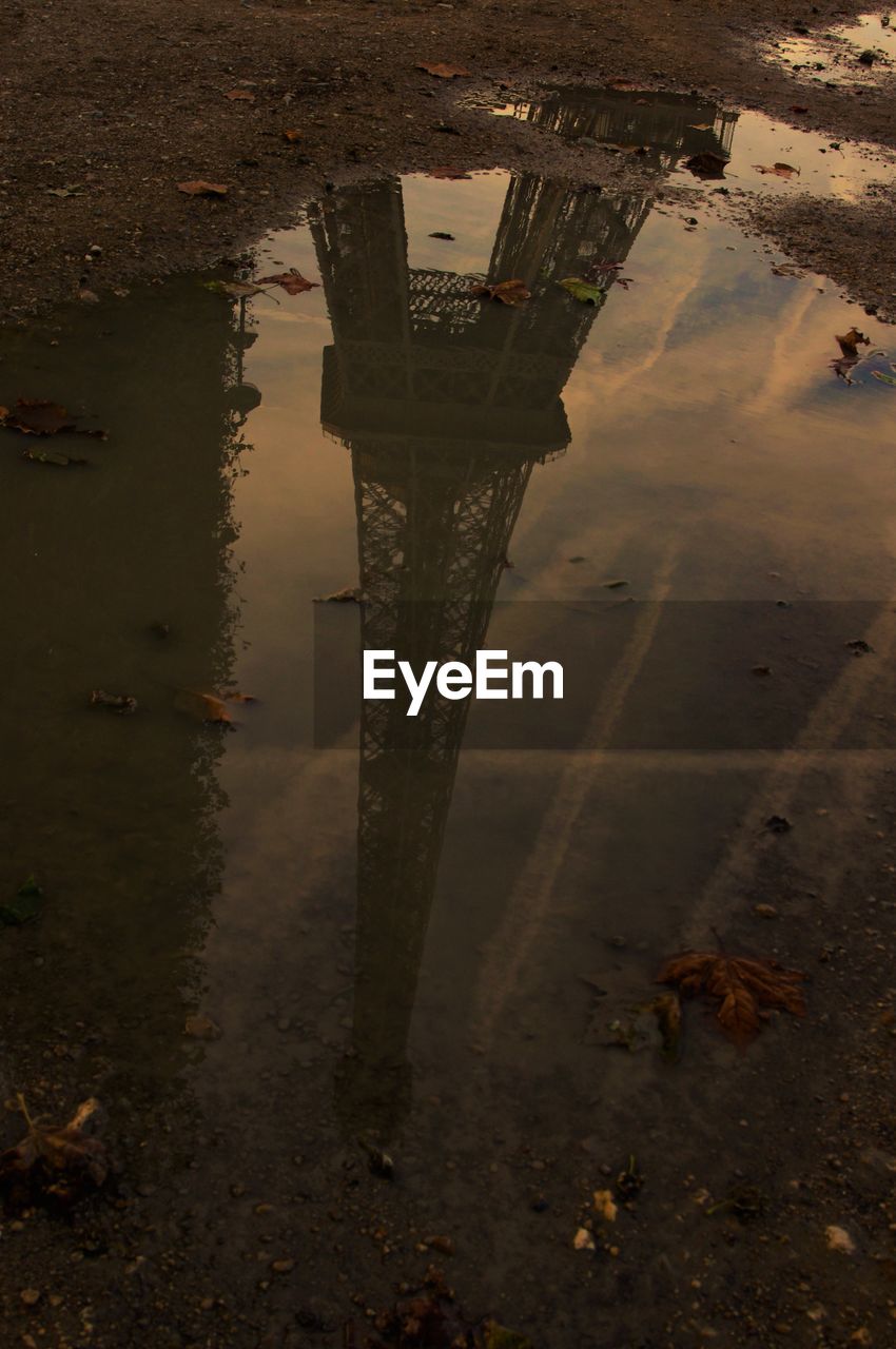 REFLECTION OF SKY AND PUDDLE IN WATER