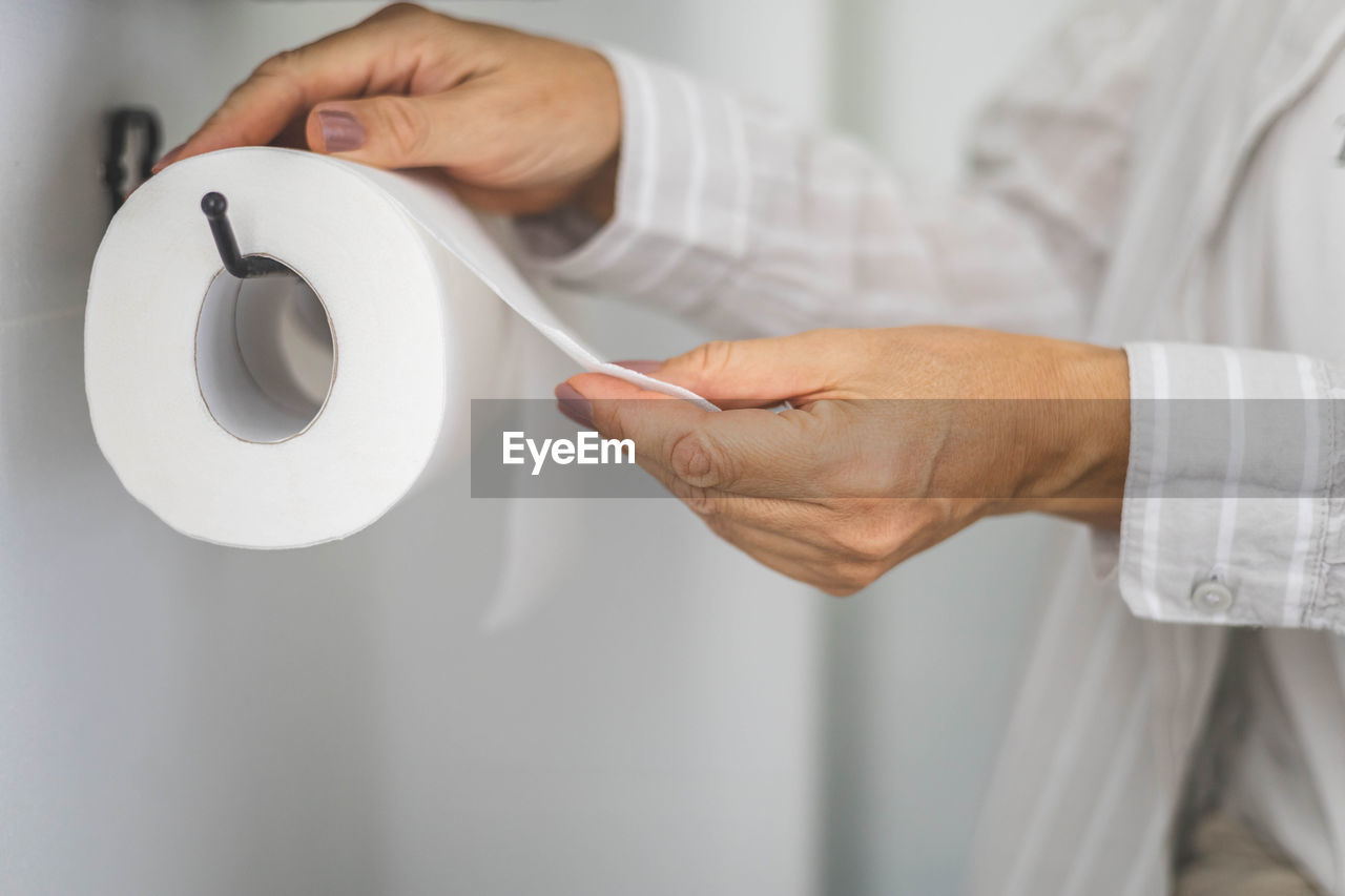 midsection of man cleaning toilet