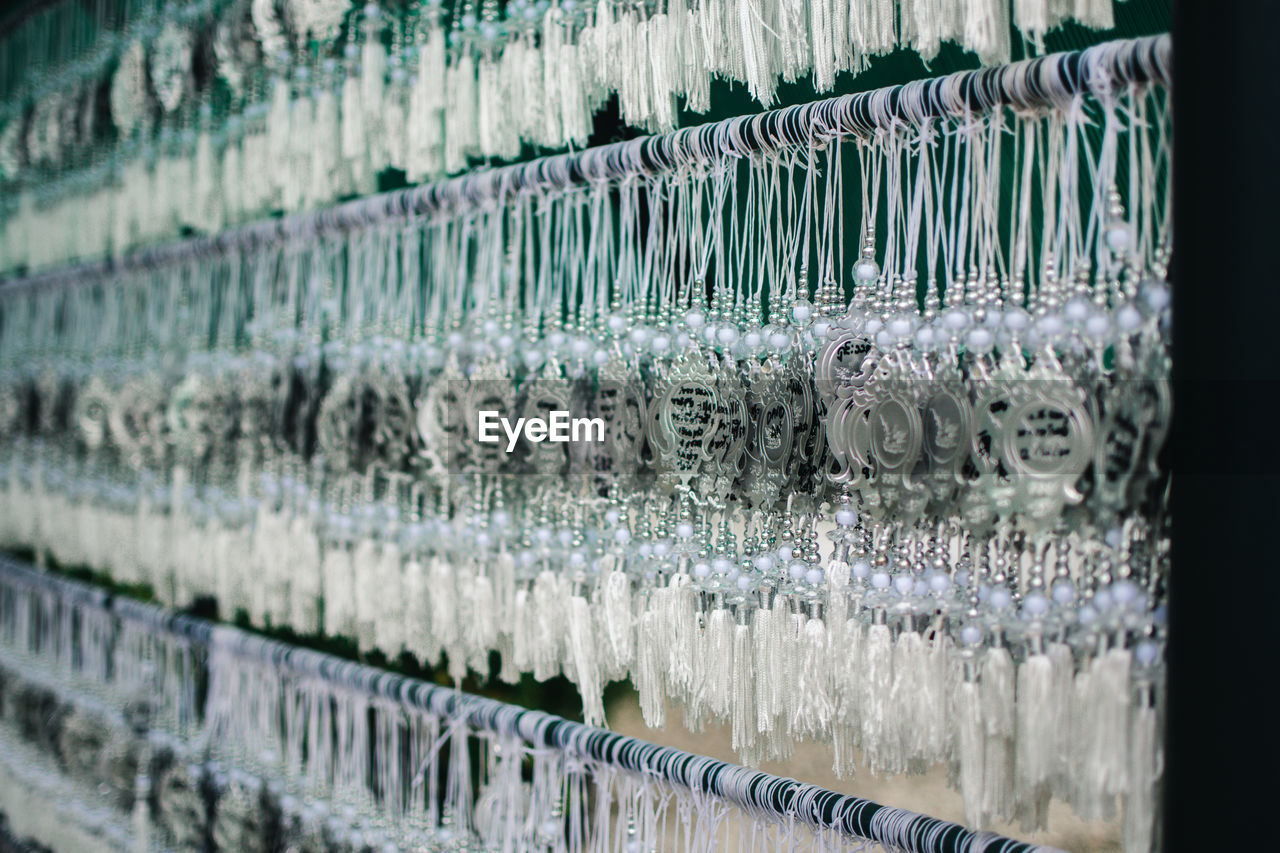 Full frame shot of wishes leaves on white temple in chiang rai