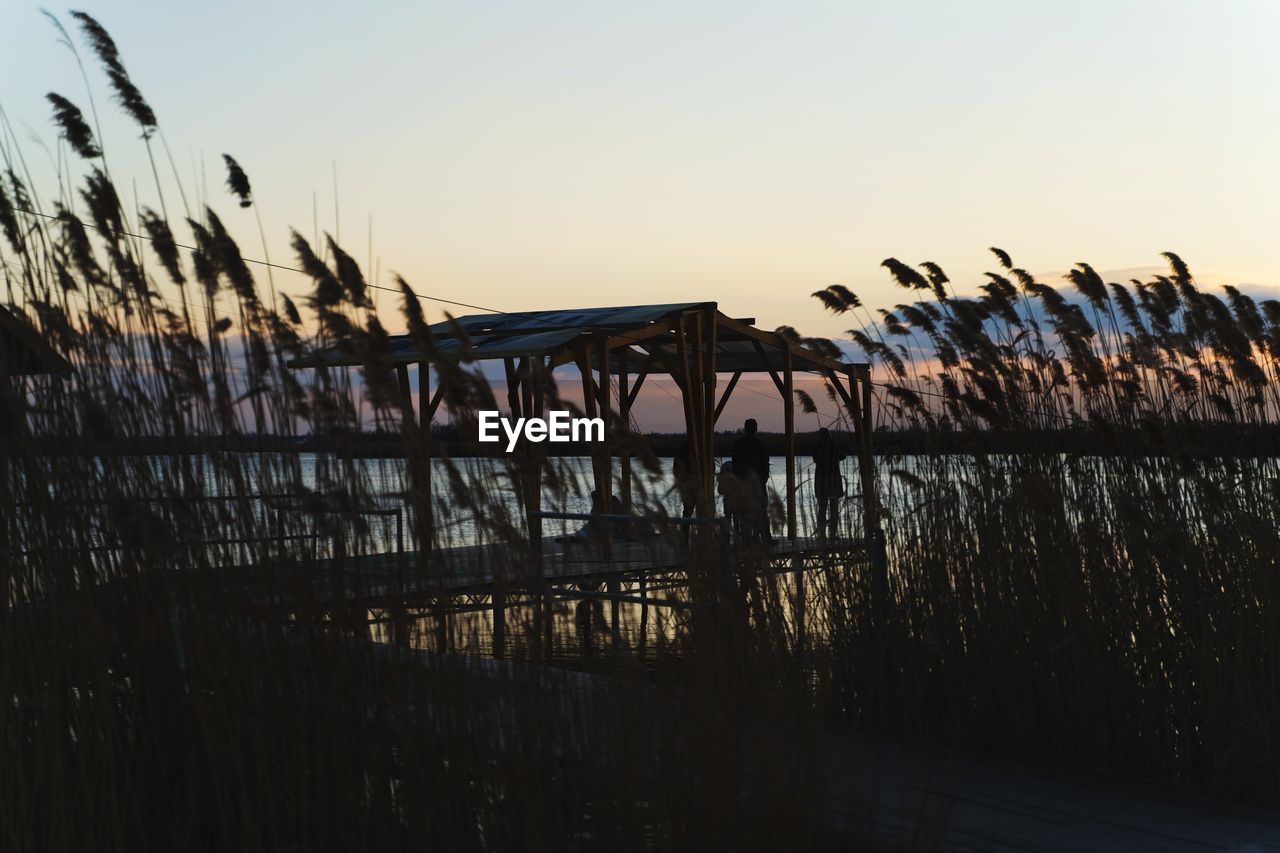 SILHOUETTE BRIDGE AGAINST CLEAR SKY AT SUNSET