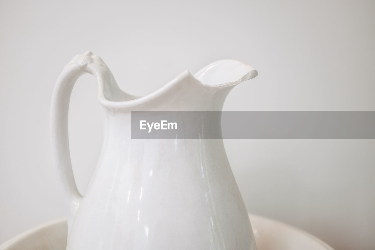 CLOSE-UP OF COFFEE CUP AGAINST WHITE BACKGROUND