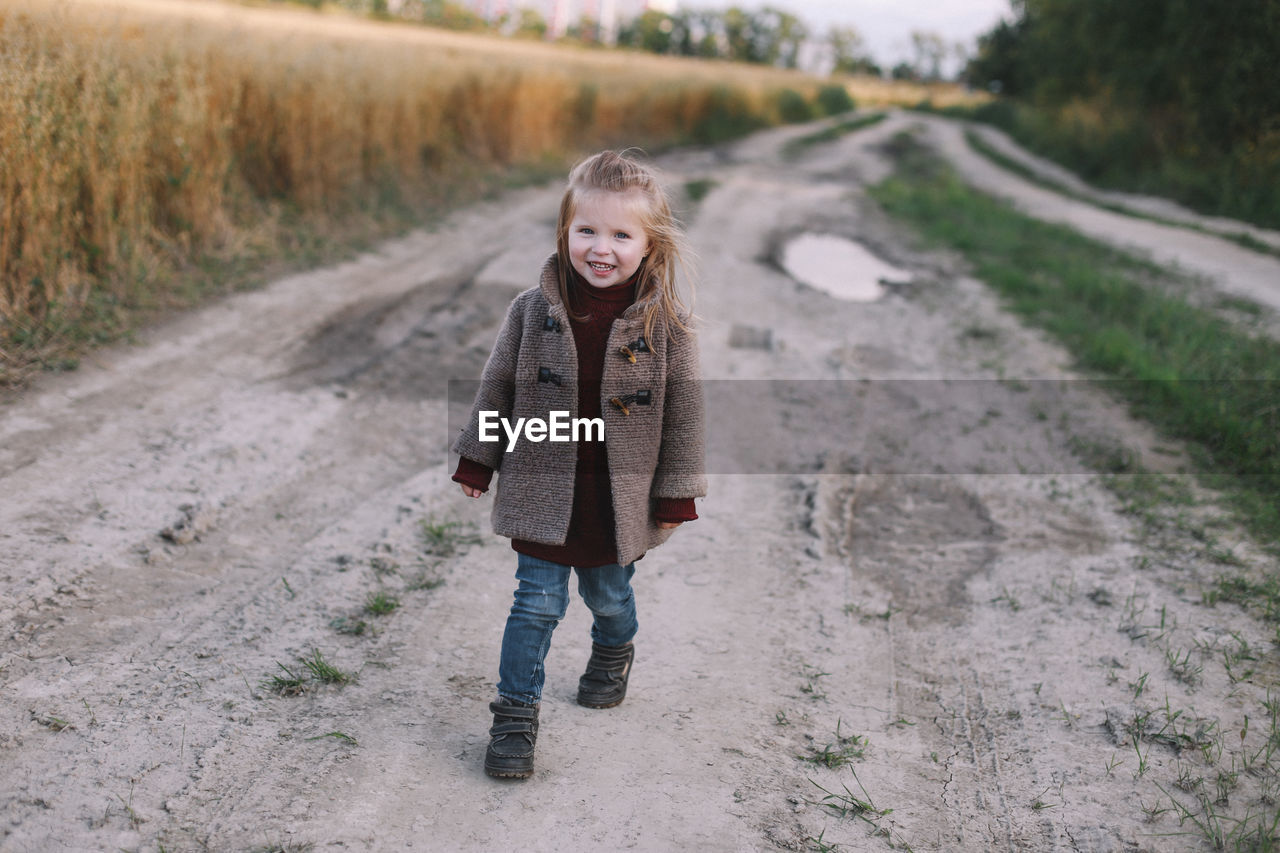 Portrait of girl standing on road