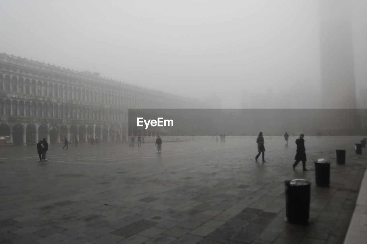 People at town square during foggy weather