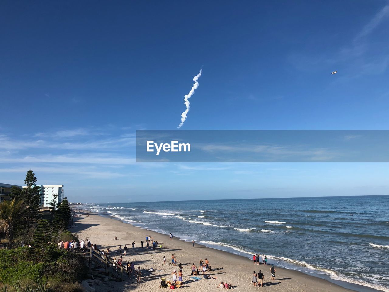 PEOPLE ON BEACH AGAINST SKY