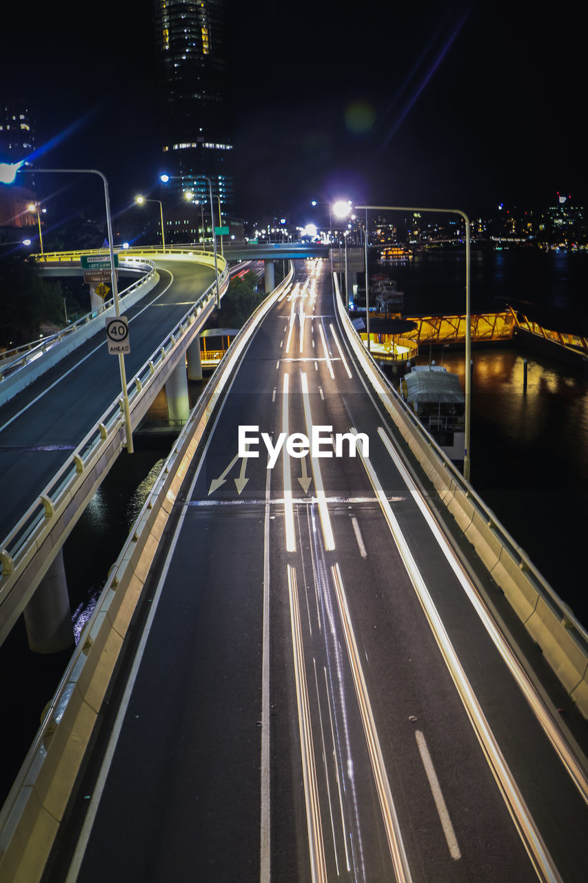 High angle view of light trails on highway at night