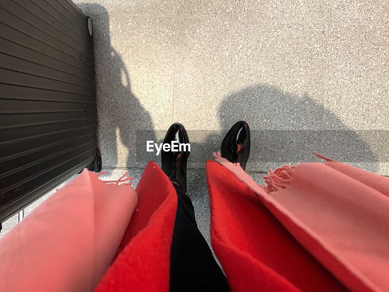 Low section of woman standing on street