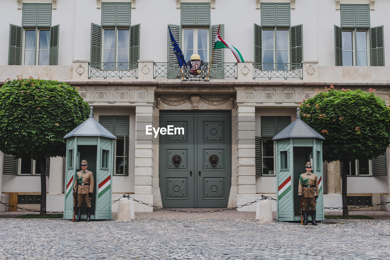 MAN STANDING OUTSIDE BUILDING