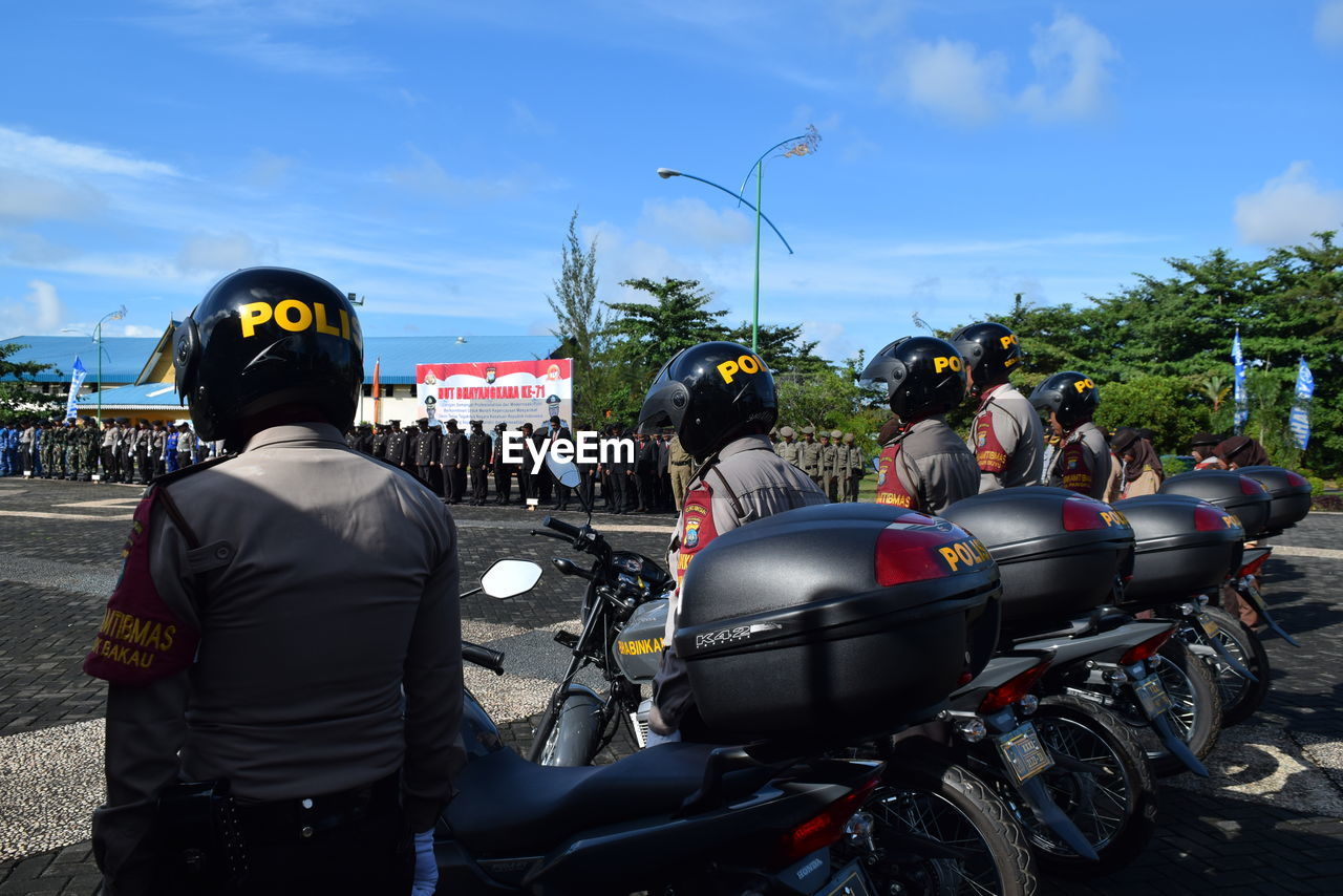 Police with motorcycles standing on road during event