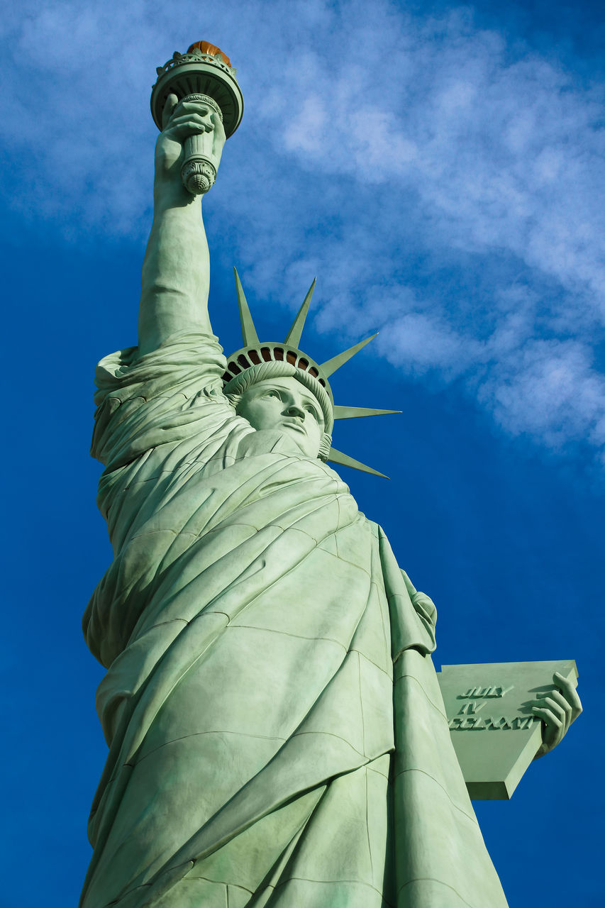 LOW ANGLE VIEW OF STATUES AGAINST CLOUDY SKY