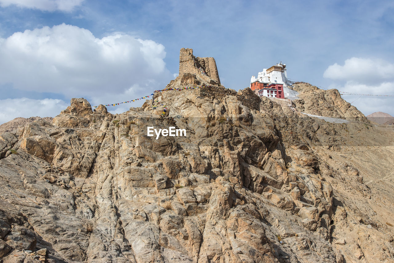 LOW ANGLE VIEW OF ROCK FORMATION AGAINST SKY