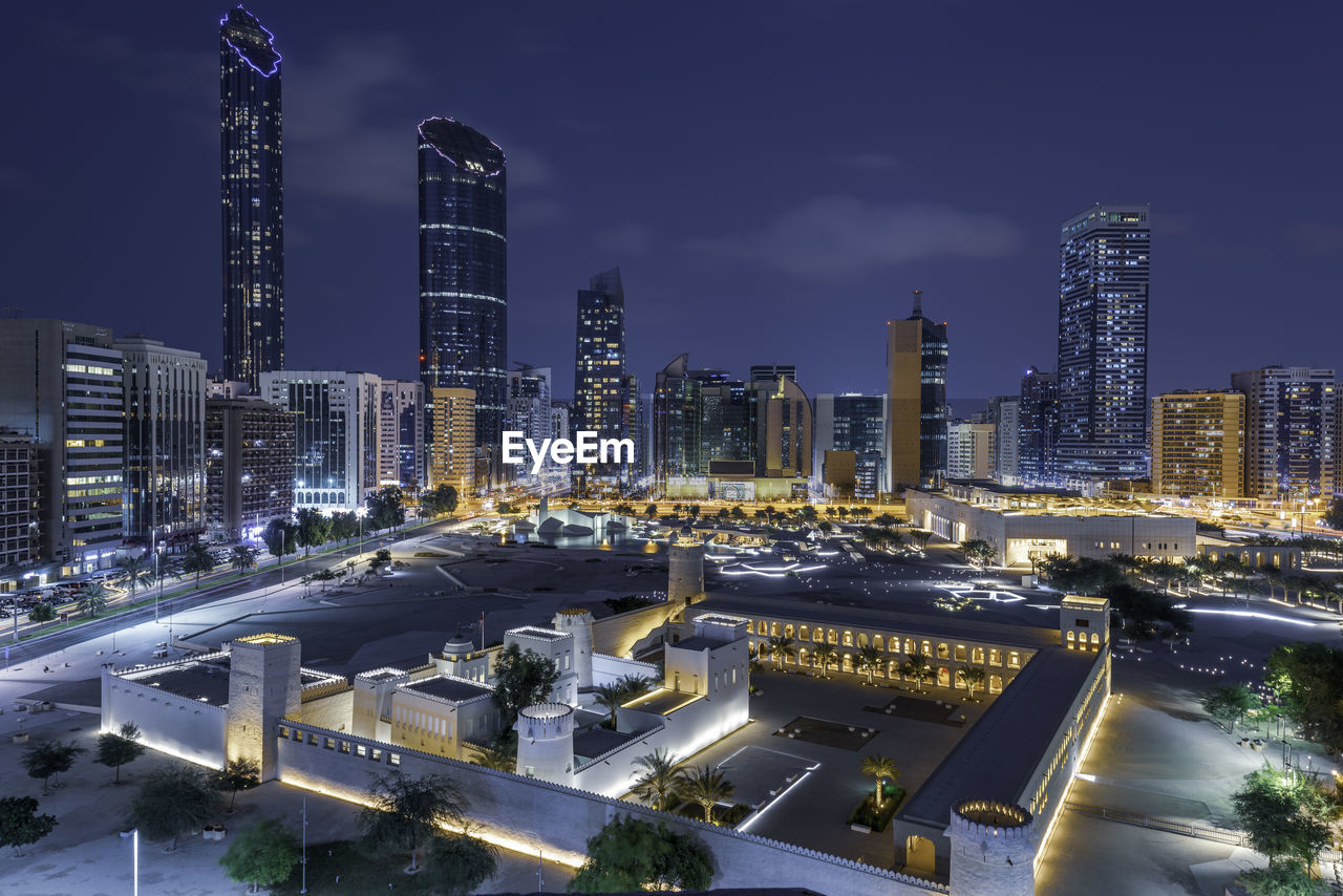 ILLUMINATED CITYSCAPE AGAINST SKY AT NIGHT