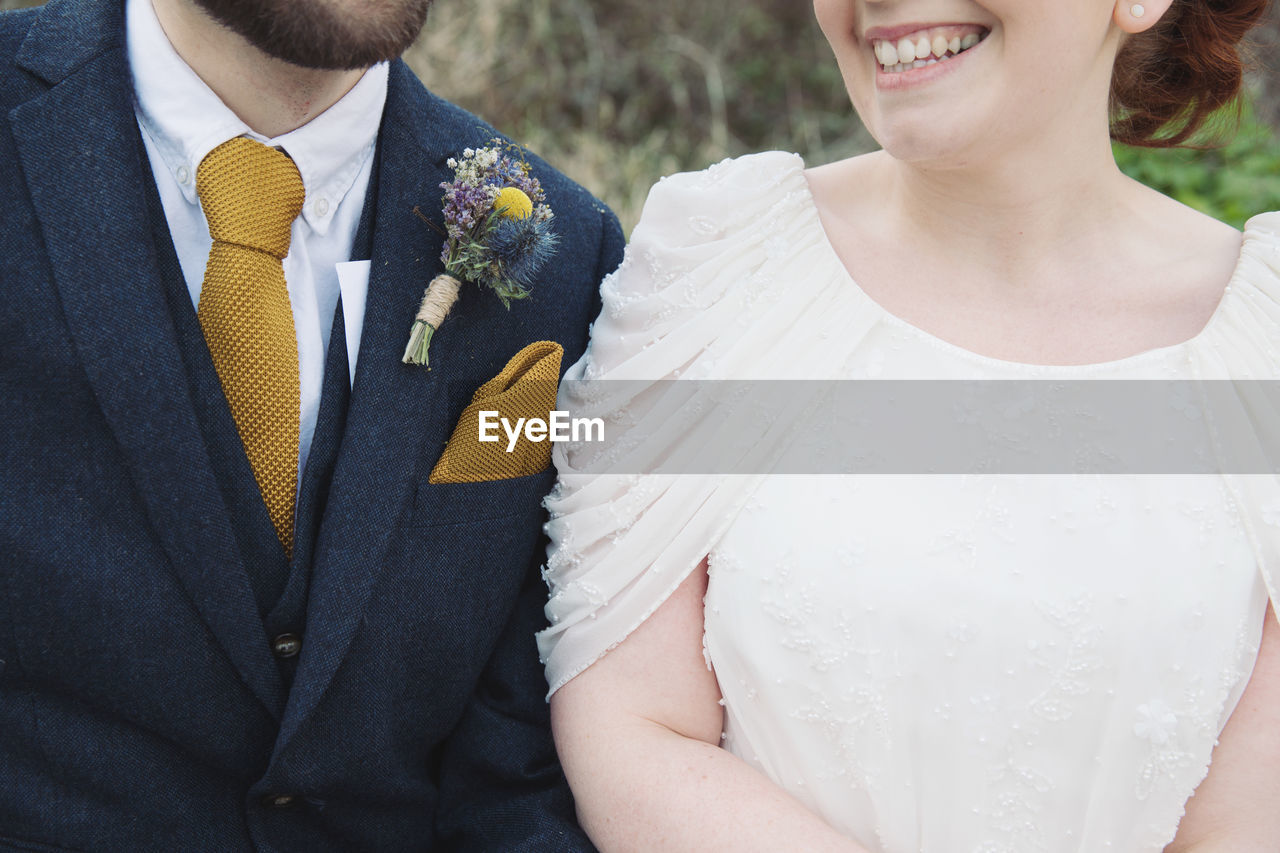Close-up of smiling woman with man outdoors