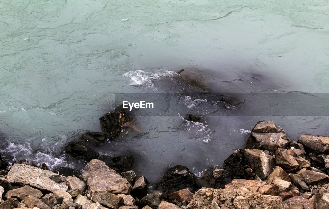 WAVES SPLASHING ON ROCKS