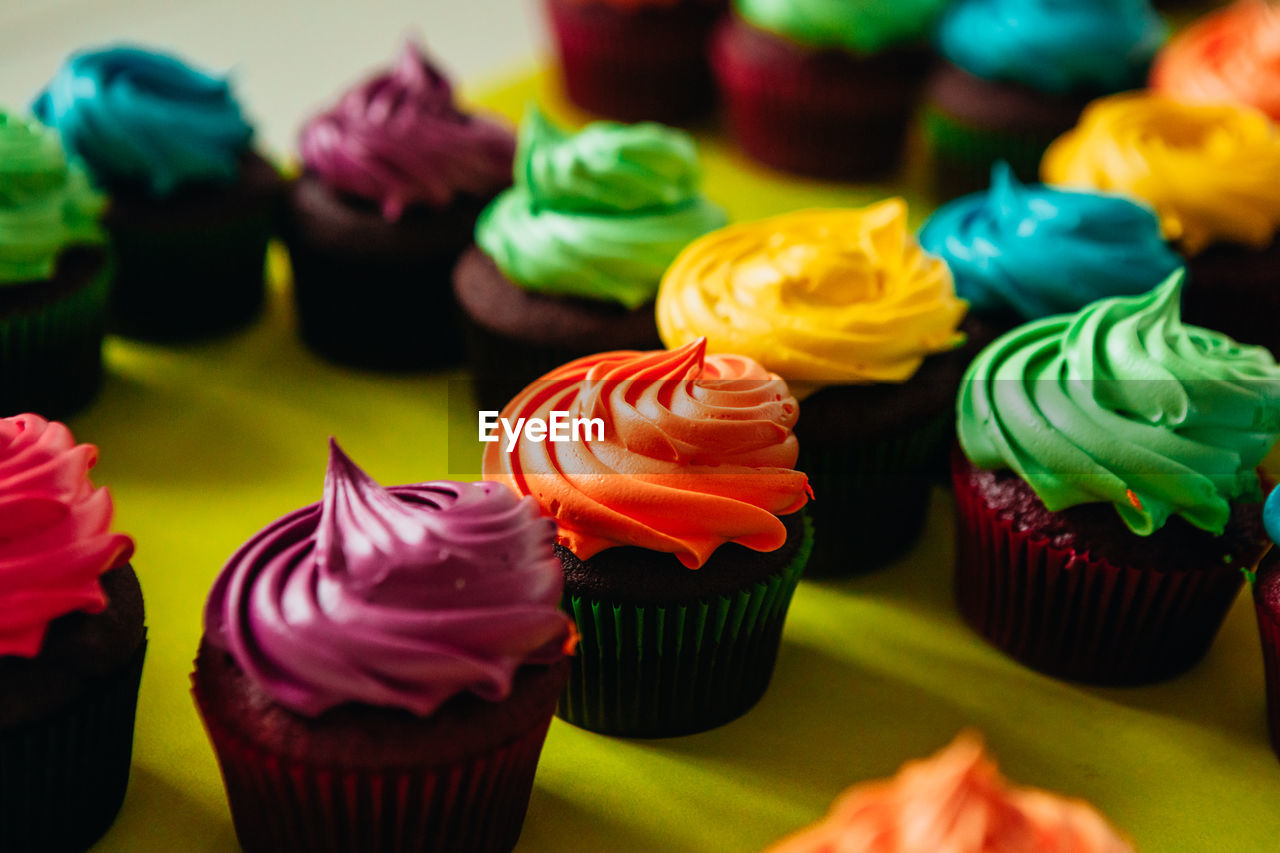 Close-up of colorful cupcakes in tray on table