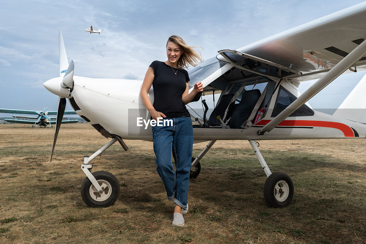 Girl near a small plane