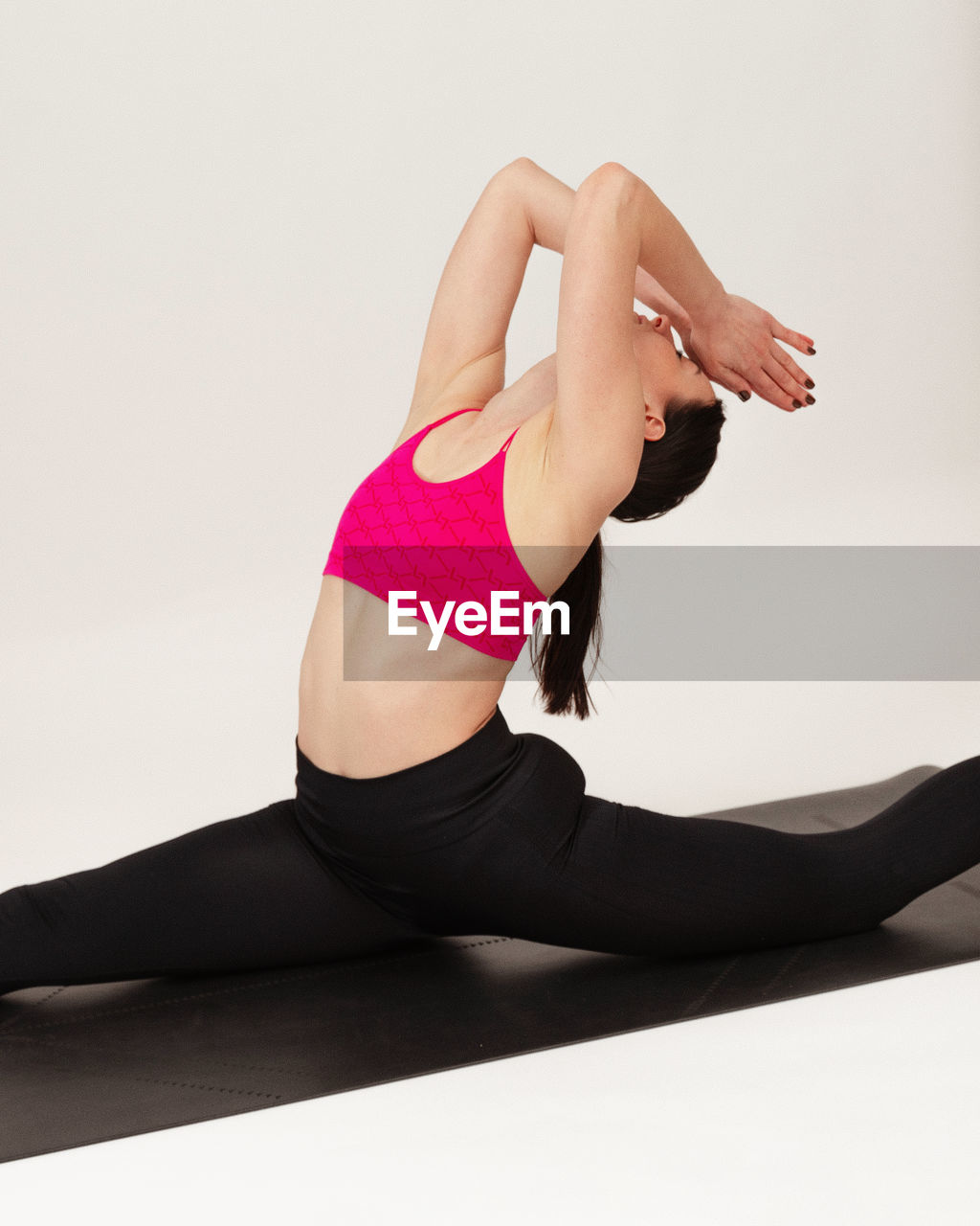 low section of woman exercising against white background