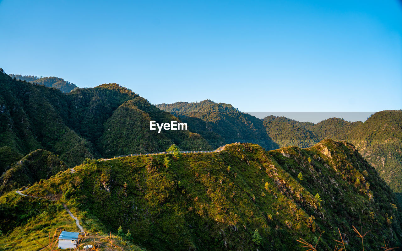 panoramic view of mountains against clear blue sky