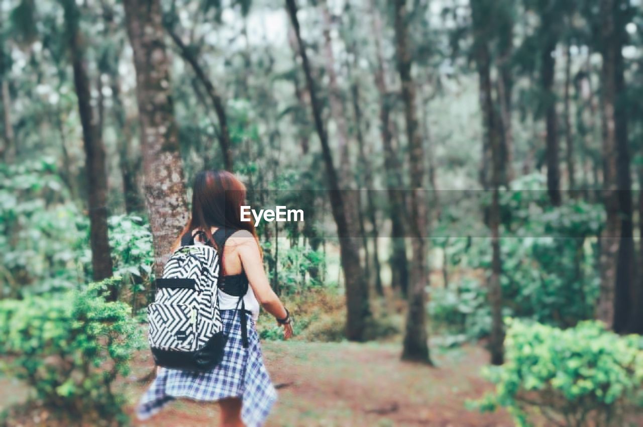 Woman walking in forest