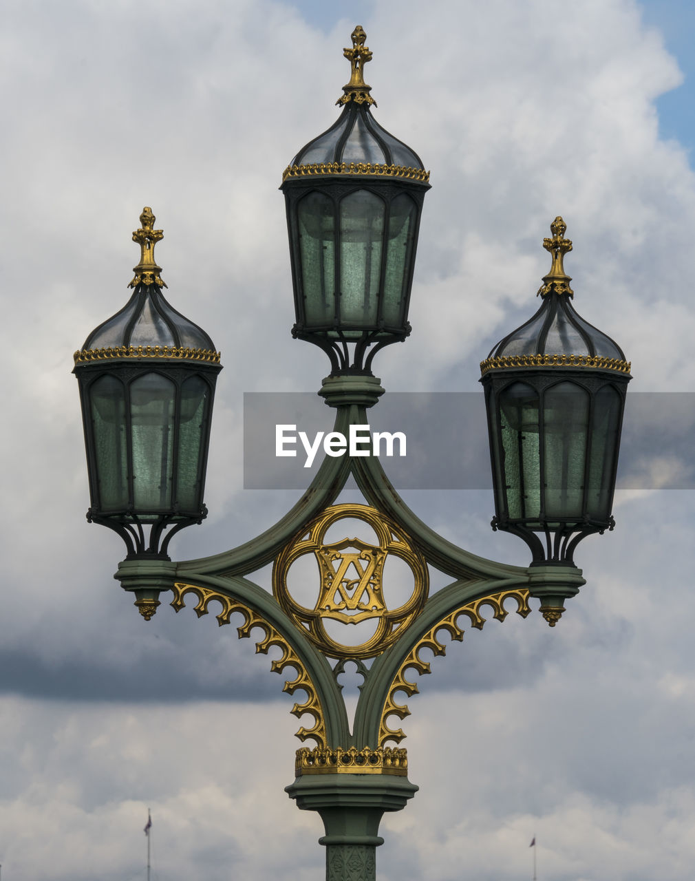 LOW ANGLE VIEW OF ILLUMINATED STREET LIGHT AGAINST SKY