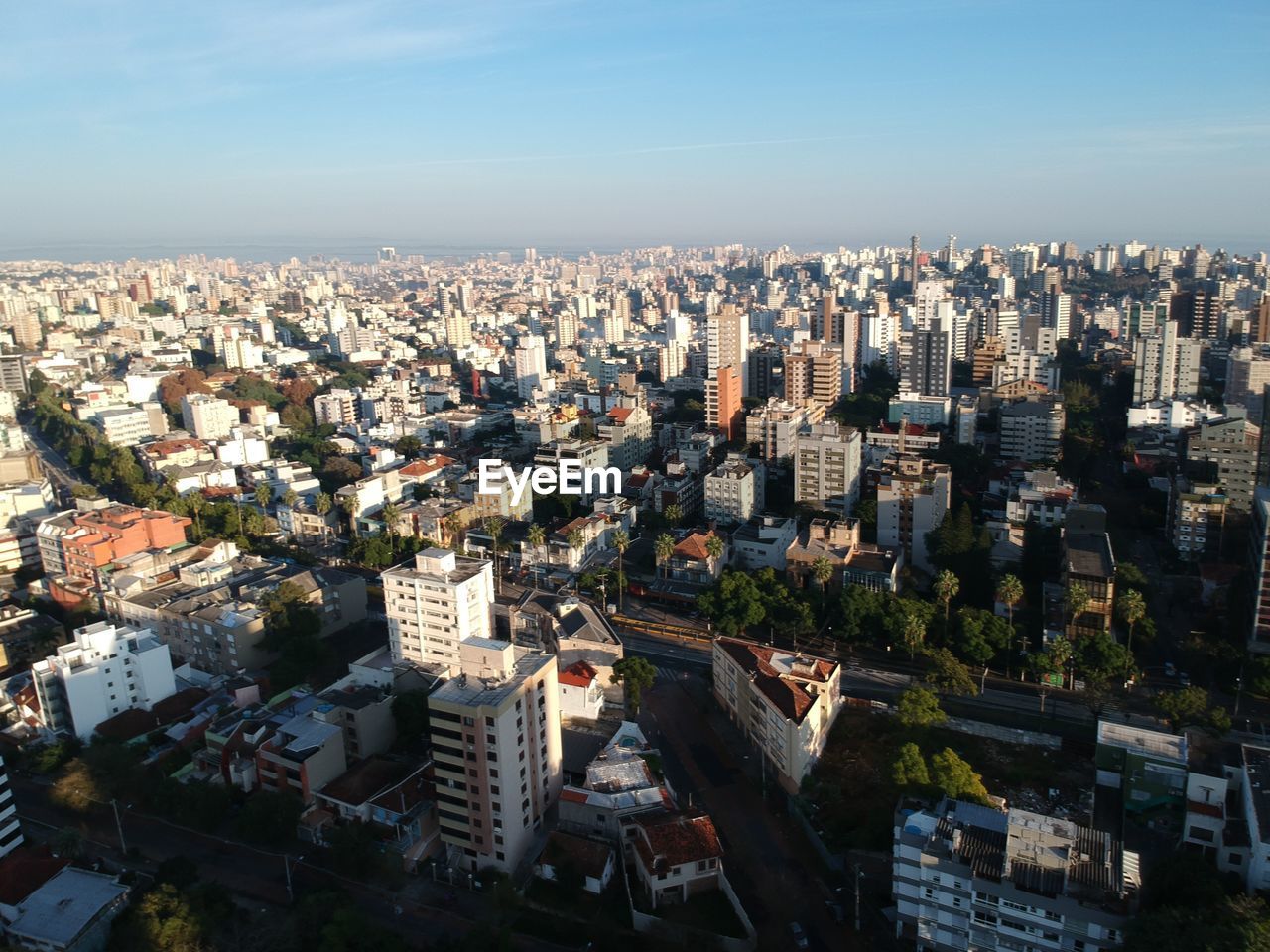 HIGH ANGLE VIEW OF BUILDINGS AGAINST SKY IN CITY