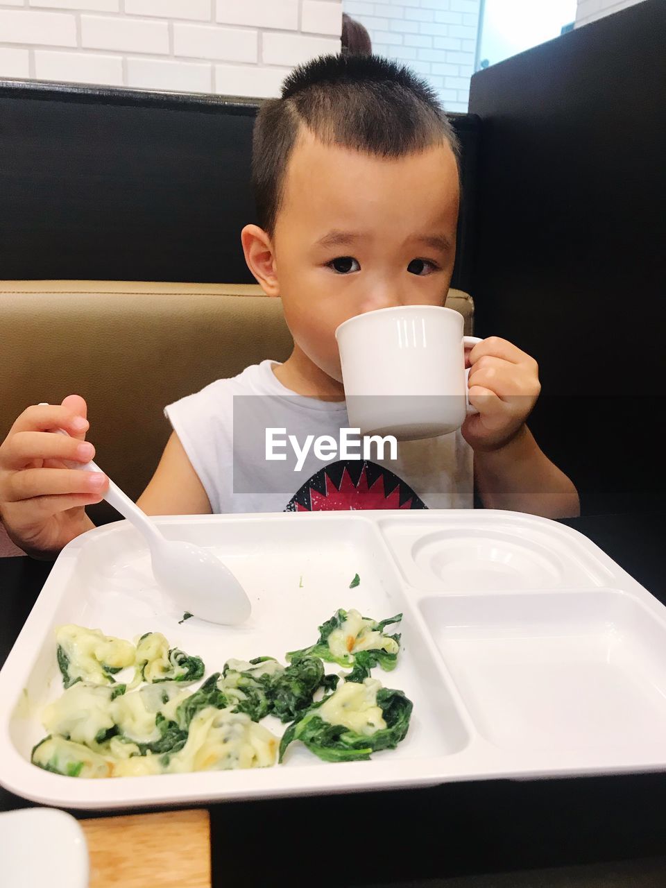 Portrait of boy having meal at table