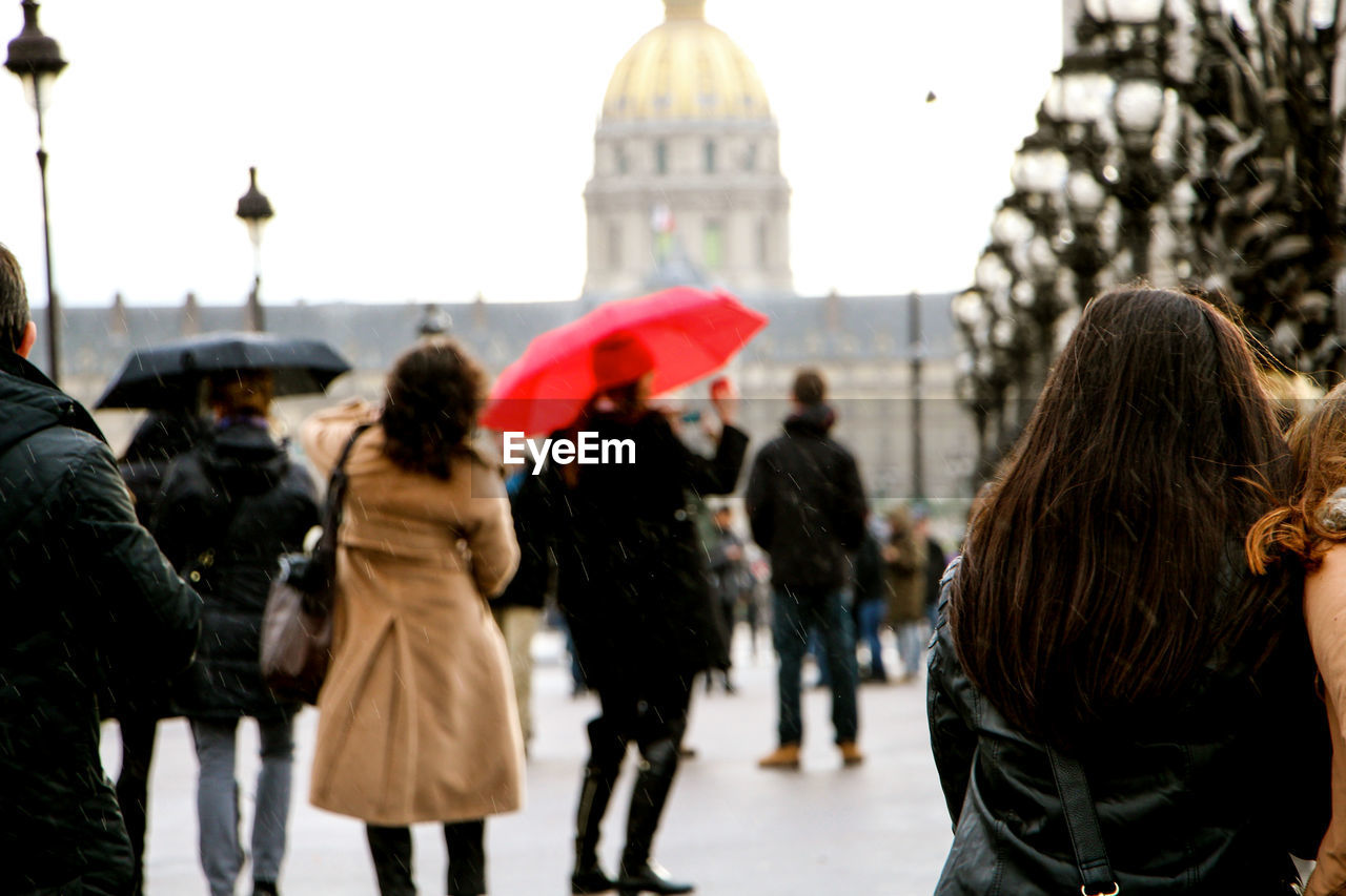 Rear view of people at les invalides during rainy season