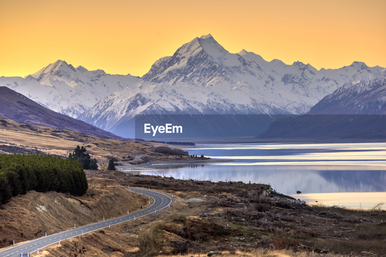 Scenic view of lake and mountains against sky