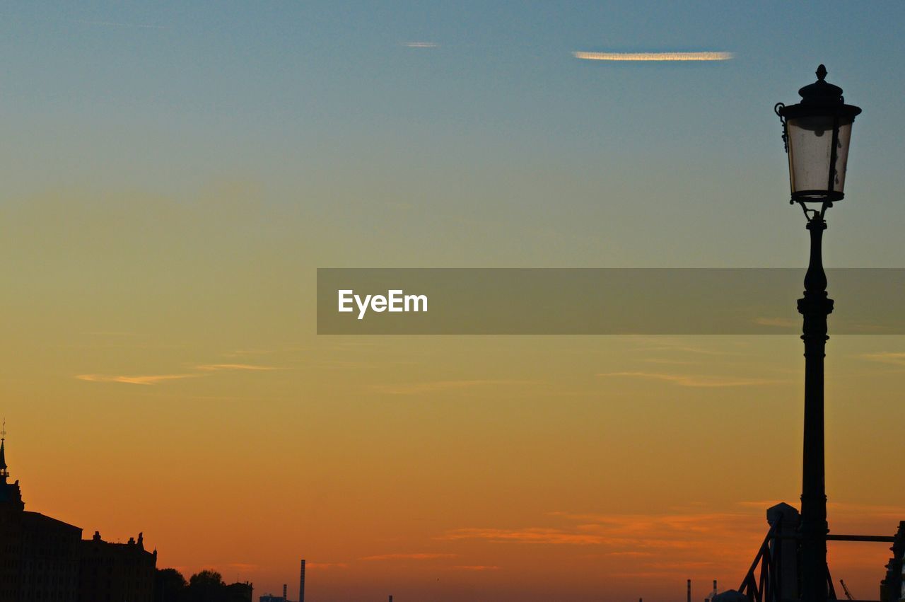 Low angle view of lamp post against sky during sunset