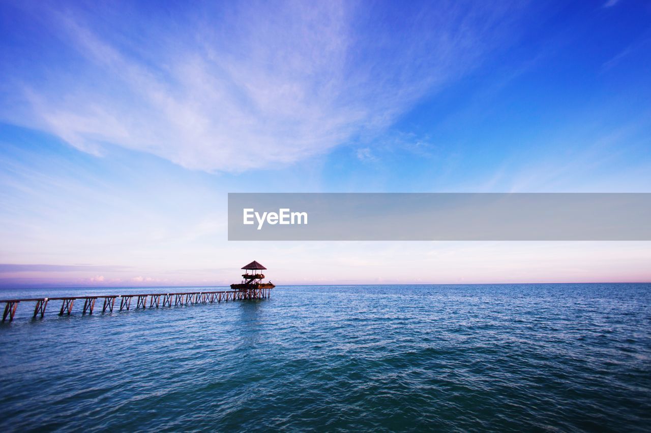 Pier over sea against sky