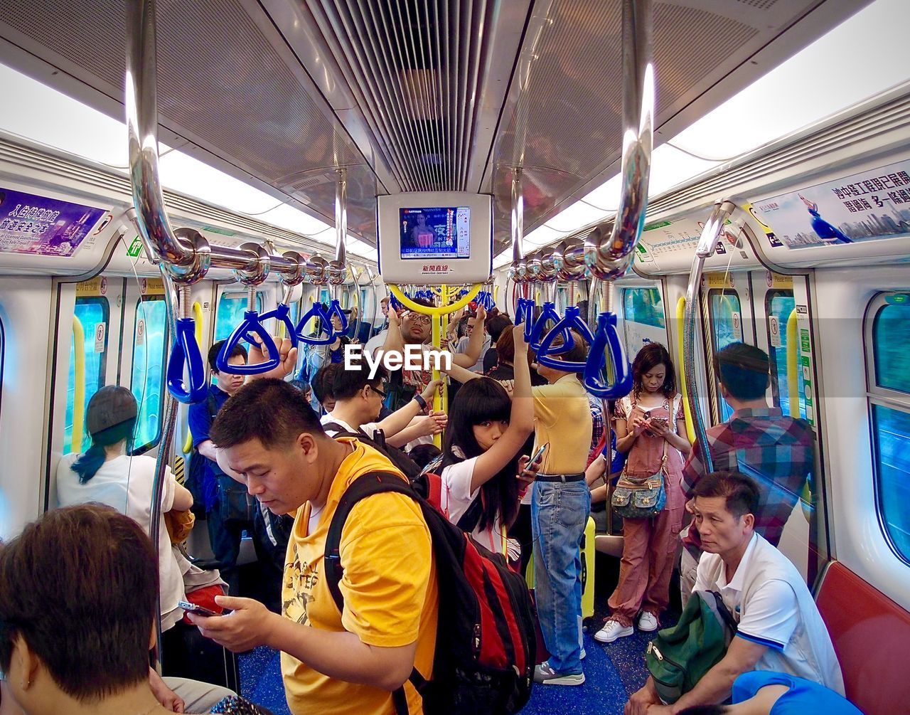 REAR VIEW OF PEOPLE STANDING ON TILED FLOOR