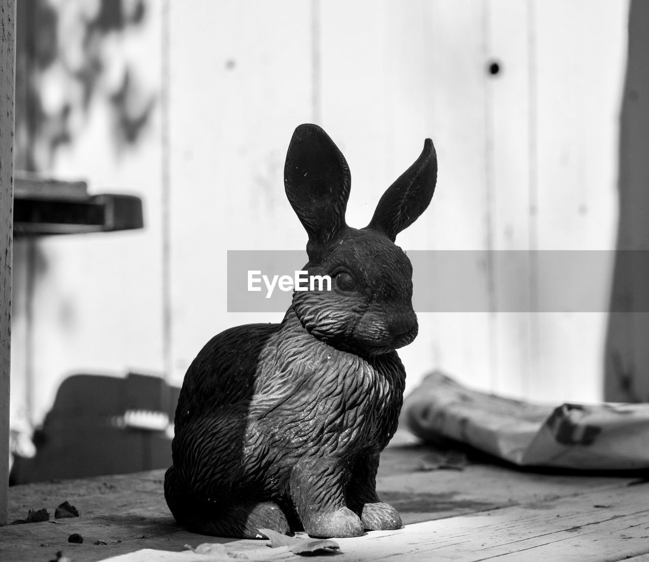 Close-up of artificial rabbit on table in back yard