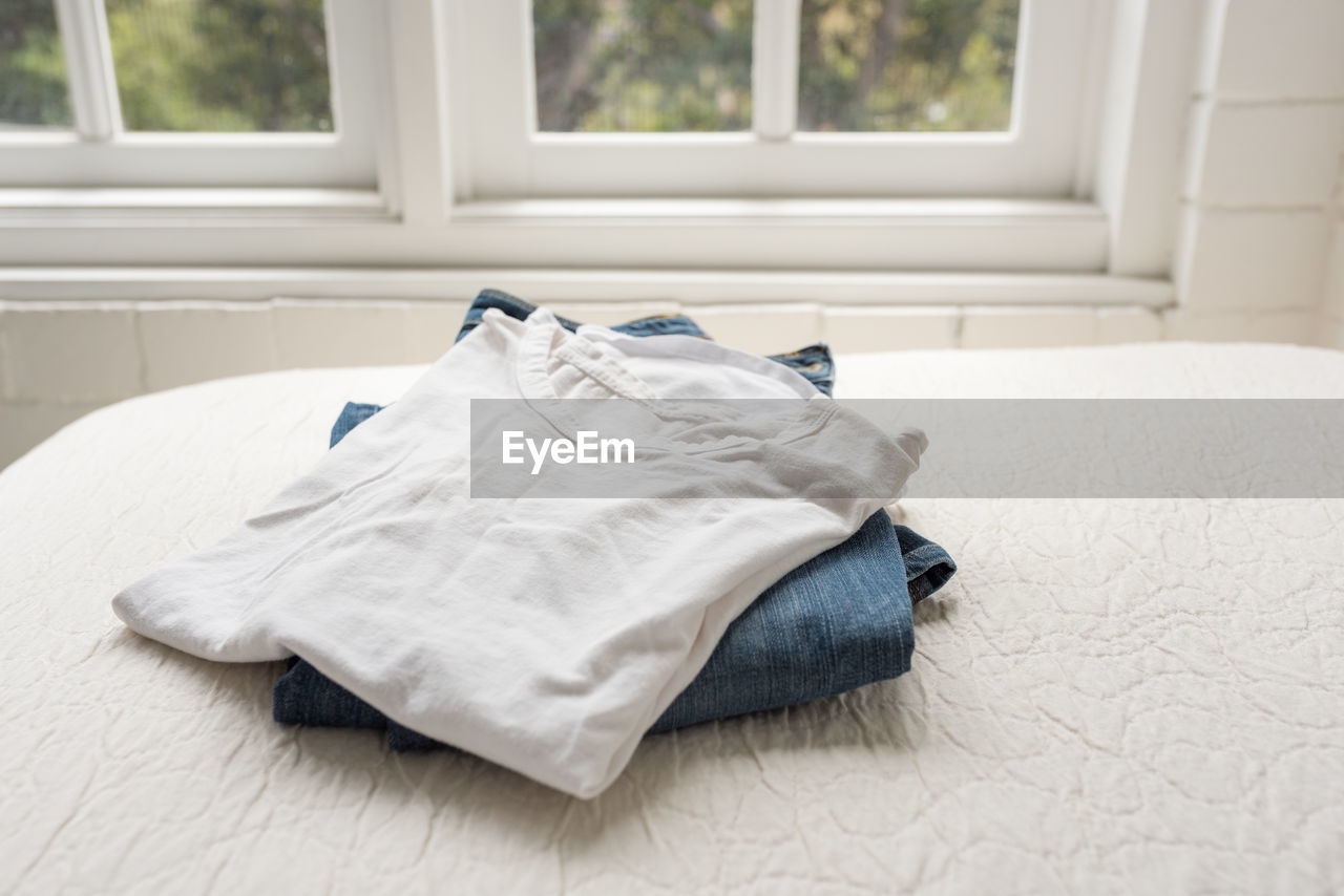 Close-up of clothing on bed at home