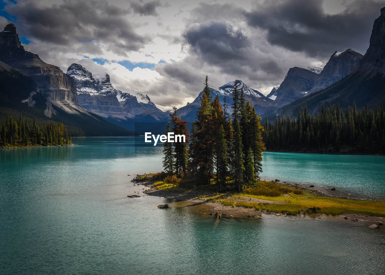 Scenic view of lake by trees against sky