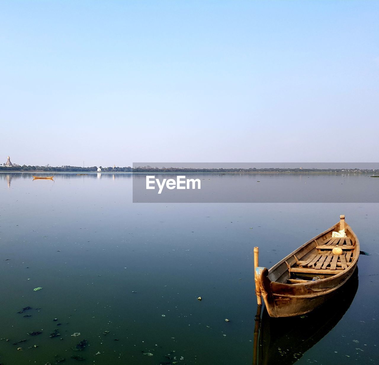 Boat moored in sea against clear sky