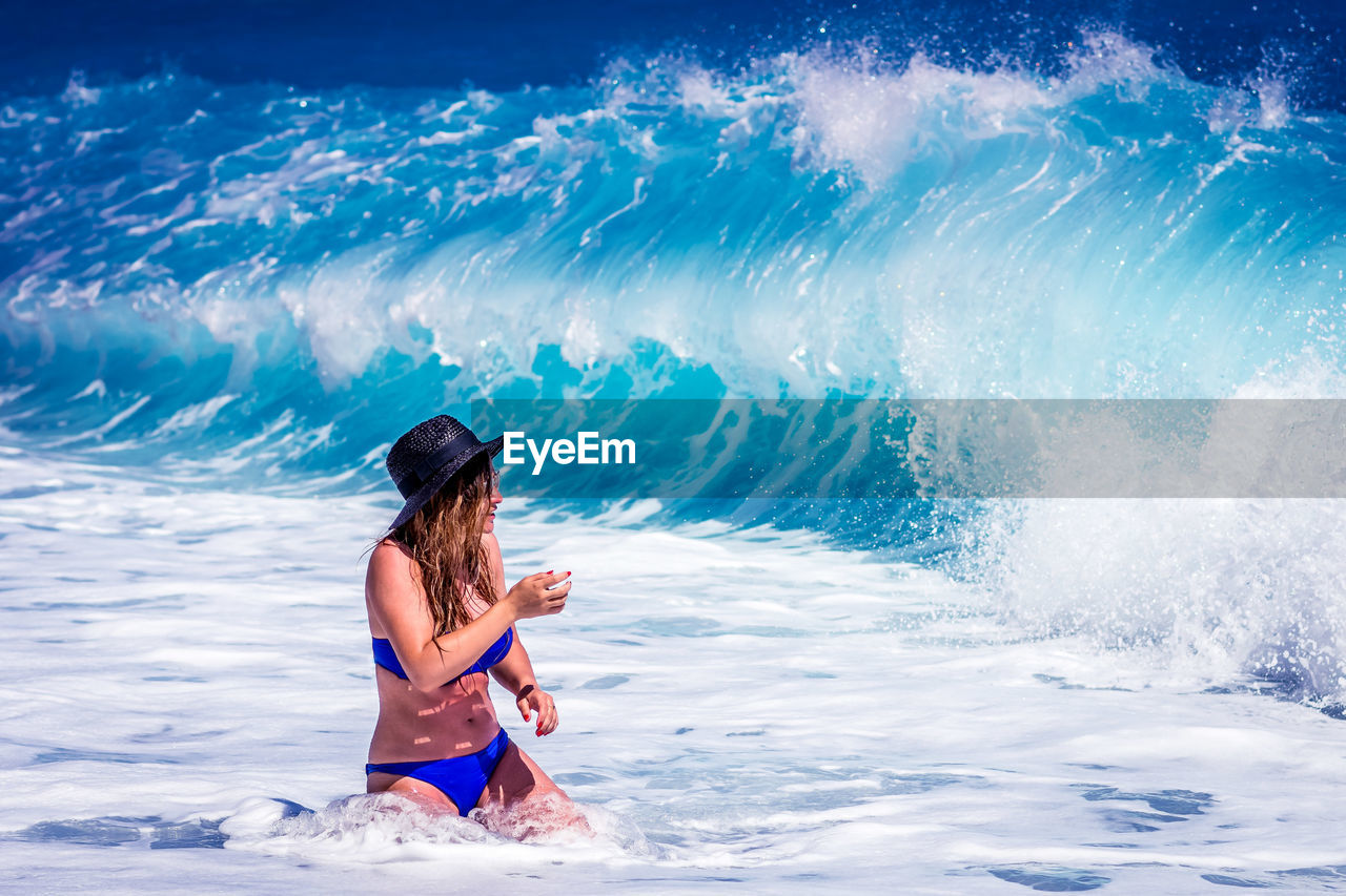 Woman wading into ocean