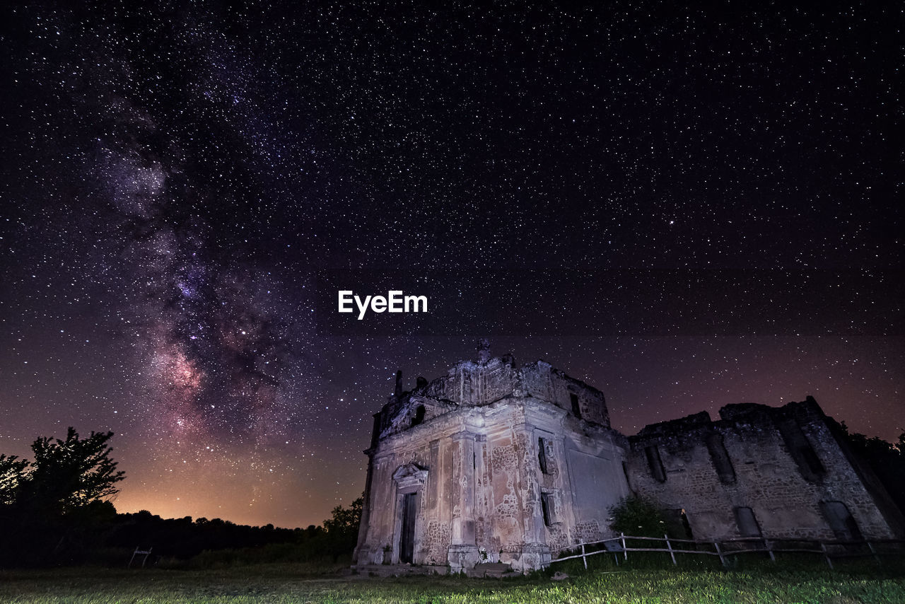 Low angle view of castle against sky at night