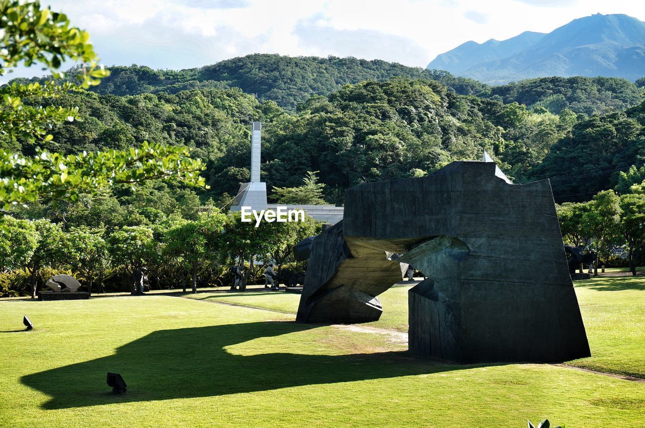 Stone monument on field in public park