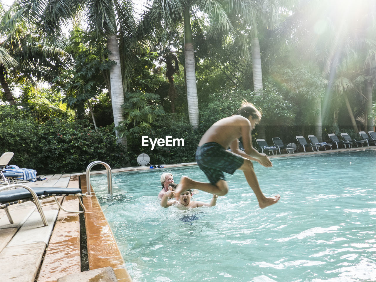 TWO MEN SWIMMING IN POOL