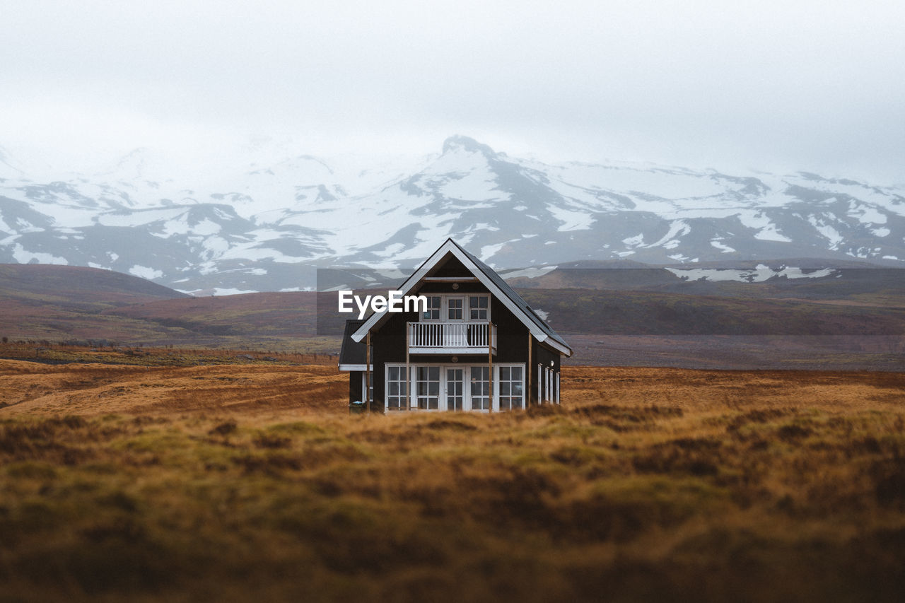 BUILT STRUCTURE ON LANDSCAPE AGAINST SKY