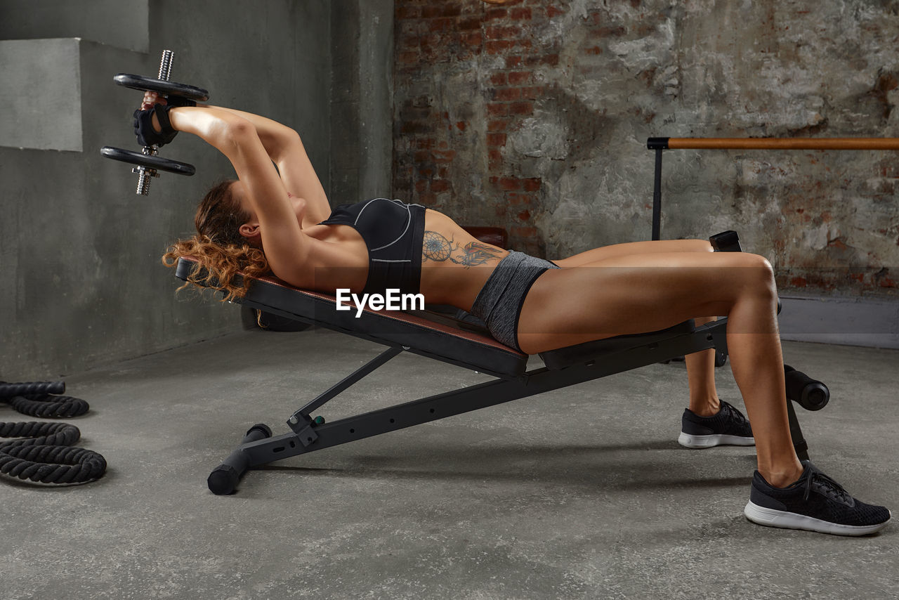 low section of man exercising on gym