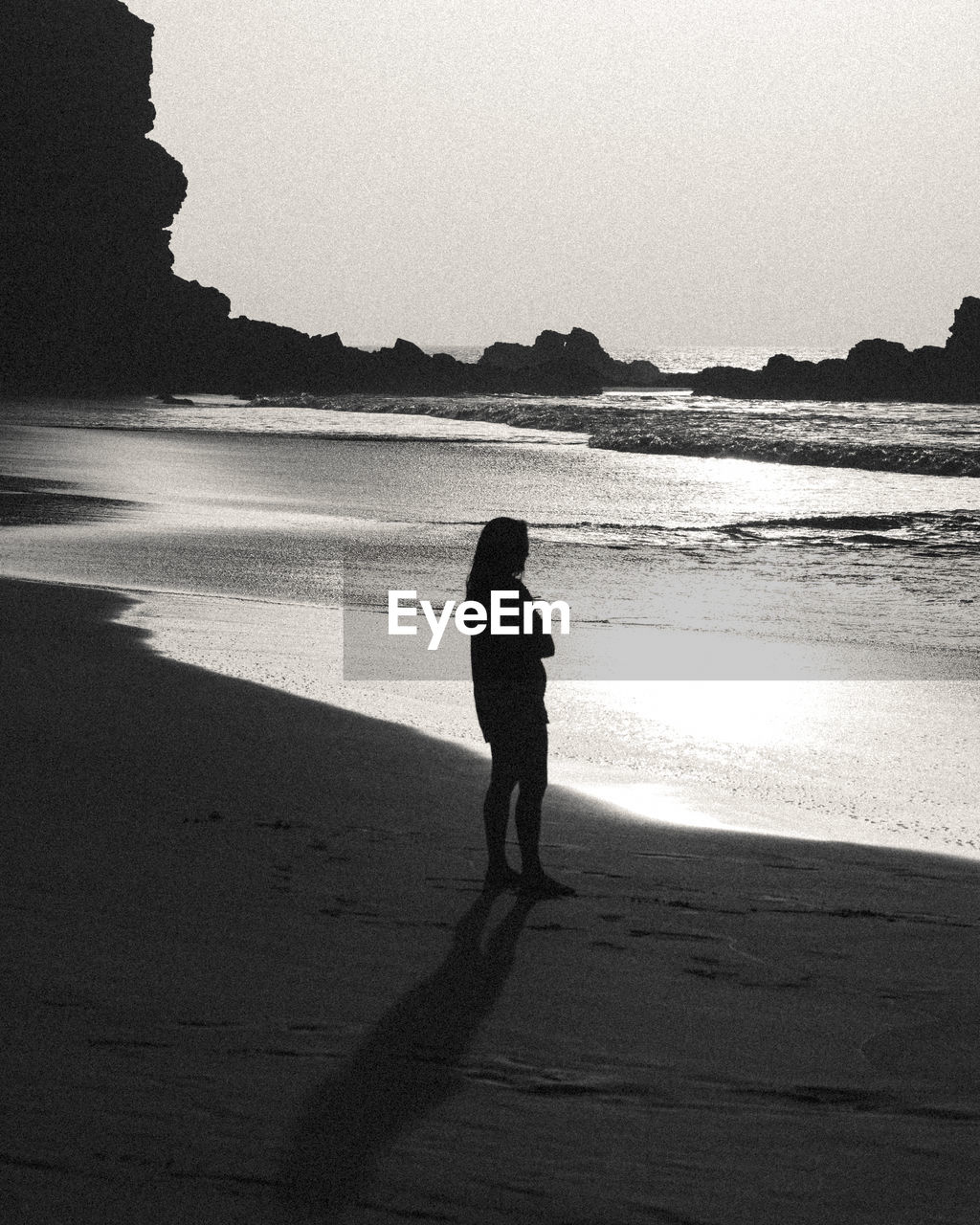 Rear view of woman walking at beach