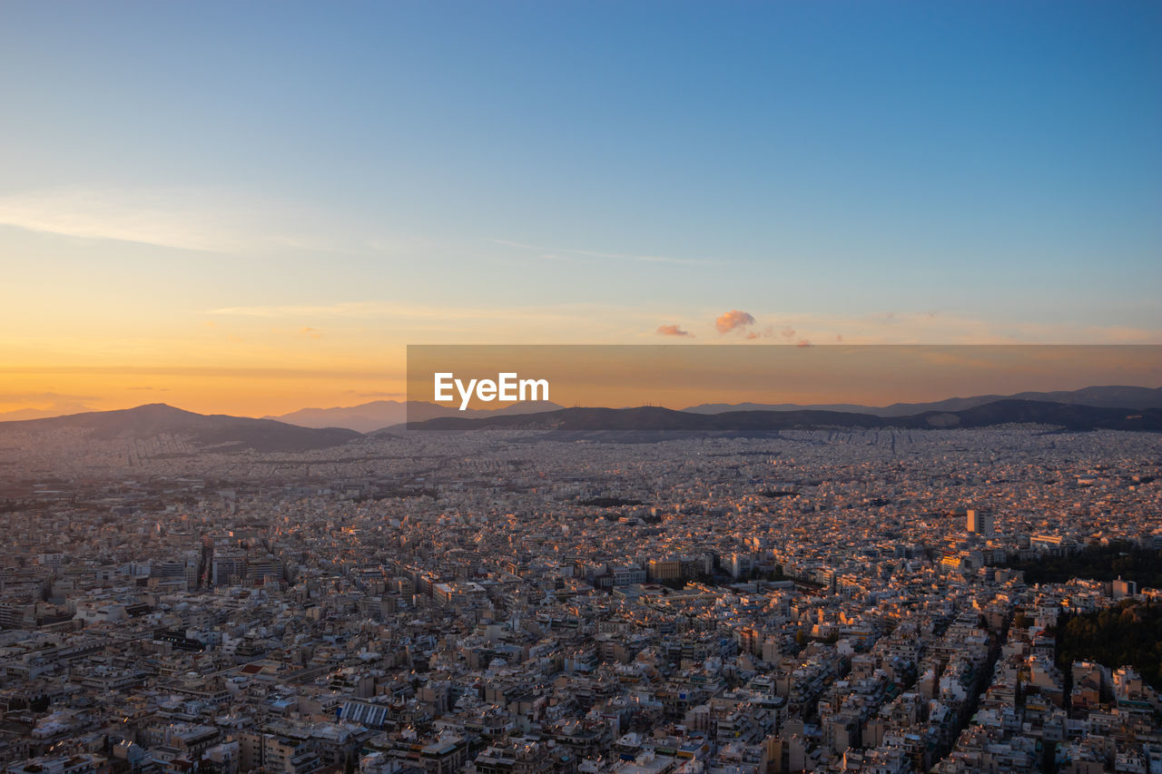 Sunset in athens on a cloudy sky with a city view from lycabettus hill in athens greece
